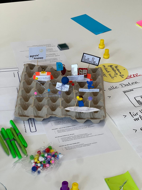 Ein Modell des Workshops hat als Basis eine graue große Eierpappe. 