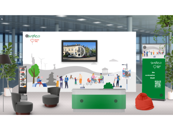 Screenshot der Darstellung des virtuellen Messestandes auf der SCCON 2023. Im Hintergrund sieht man eine virtuelle Präsentationswand, davor Sitzmöbel und eine Theke. Alles ist in dn Farben grün und weiß gehalten. 